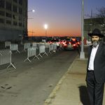 Mayer Kotlarsky awaits a friend's arrival outside the International Conference of Chabad-Lubavitch Emissaries banquet at the South Brooklyn Marine Terminal on Sunday night. <br/>(Nathan Tempey/Gothamist)